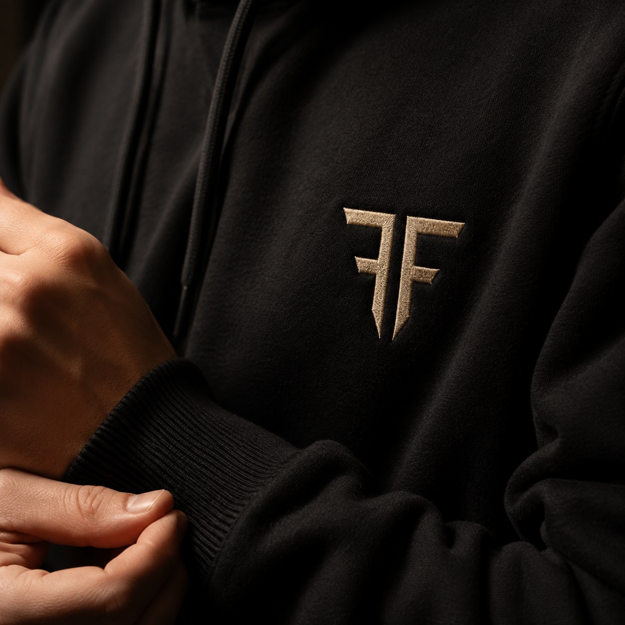 Close detail of the embroidered Faith Above Fear monogram